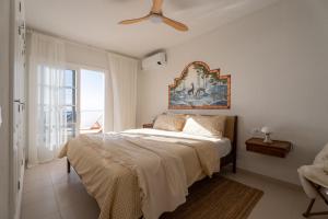 a bedroom with a bed and a ceiling fan at Mosaico Ocean View Boutique Apartment in Adeje +43 photos