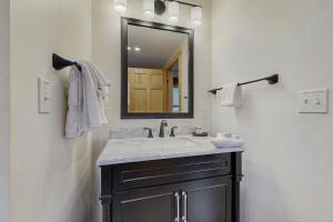 a bathroom with a sink and a mirror at The Grouse House in Greenville +11 photos