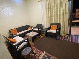 a living room with couches and chairs and a table at Mohmad House in Jurf ad Darāwīsh +6 photos