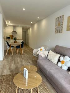 una sala de estar con un sofá y una mesa en Apartamentos La Margarita, en Santillana del Mar