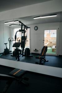 a gym with several chairs and a mirror at Casa vacanze da Pino A in Torchiarolo