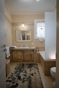 a bathroom with a sink and a toilet and a mirror at Casa vacanze da Pino A in Torchiarolo +29 photos