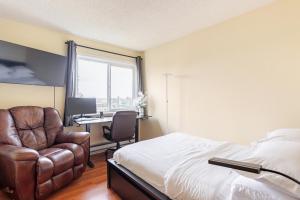 a bedroom with a bed and a chair and a desk at Cozy and Secure 3-Bedroom, 2-Bath Unit with 6 Beds and Beautiful Bay View in Albany