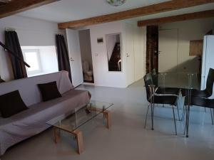 a living room with a couch and a glass table at Mäo Apartment in Mäo