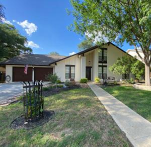 a house with a tree in front of it at The Ultimate Staycation in San Antonio