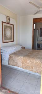 a bedroom with a large bed in a room at HOTEL VILLAS XAIBA in Puerto Escondido