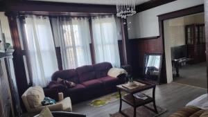 a living room with a purple couch and a table at Valley and city views in Steubenville