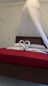 Tempat tidur dalam kamar di Alen's Stay&surf