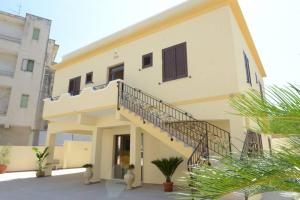 a building with a staircase on the side of it at B&B IN VILLA in Gallipoli