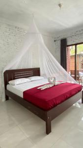 Tempat tidur dalam kamar di Alen's Stay&surf
