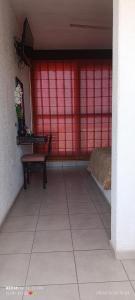 a room with a red wall with a bed and a table at HOTEL VILLAS XAIBA in Puerto Escondido