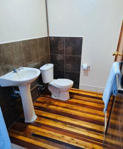 a bathroom with a toilet and a sink at Travel Hotel Quito in Quito