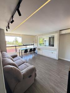 a living room with a couch and a table at Suites Premium 2 quartos in João Pessoa