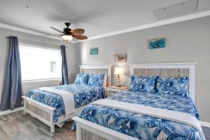 a bedroom with two beds and a ceiling fan at Ocean Isles Peace and Serenity in Marathon +44 photos