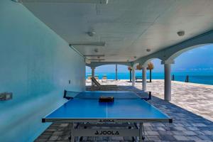 a ping pong table in a room with a view of the ocean at Ocean Isles Peace and Serenity in Marathon
