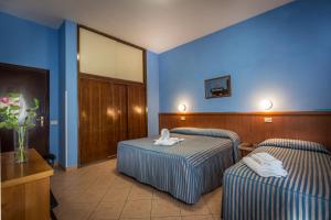 Postel nebo postele na pokoji v ubytování Hotel Real