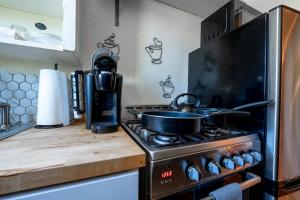 a kitchen with a stove with a pot on it at Spring Serenity Chic 1BR Apt Walk to UofA in Tucson