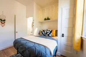 a bedroom with a bed with a blue comforter at Spring Oasis Tucson 1BR 5 Min to UofA and Fun in Tucson