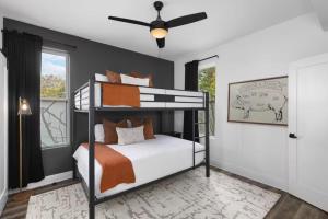 a bedroom with a bunk bed and a ceiling fan at Walk Geodis Stadium Restaurants Rooftop EV Garage in Nashville