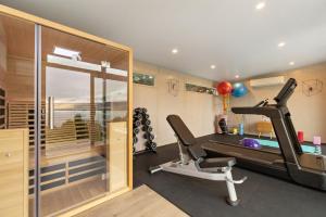 a fitness room with a treadmill and a gym at Baywaters Retreat by Sothebys Luxury Rental Homes in Closeburn
