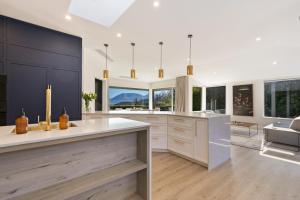 a kitchen with white cabinets and a large window at Baywaters Retreat by Sothebys Luxury Rental Homes in Closeburn +21 photos
