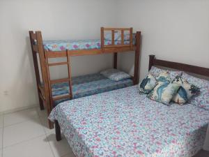 a bedroom with two bunk beds and a bed at Maravilha do Patacho in Pôrto de Pedras +7 photos