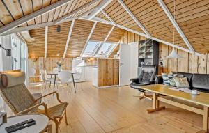 a living room with wooden ceilings and a table and chairs at Nice Home In Vinderup With Kitchen in Vinderup