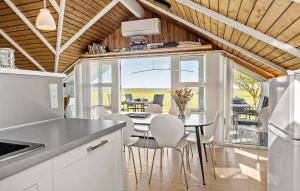 a kitchen and dining room with a table and chairs at Nice Home In Vinderup With Kitchen in Vinderup