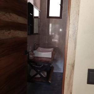 a bathroom with a sink and a mirror at Cabaña Arelys in Cedro