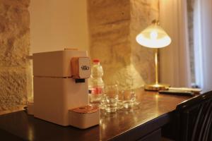 a bottle of water and glasses on a table at Petrakis Inn in Jerusalem