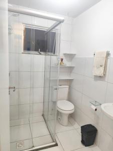 a white bathroom with a toilet and a sink at Cantinho da harmonia-Morada Nova in Petrolina