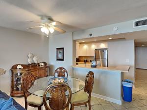 a dining room and kitchen with a glass table and chairs at Perdido Sun #410 in Perdido Key