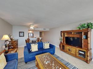 a living room with blue furniture and a flat screen tv at Perdido Sun #410 in Perdido Key
