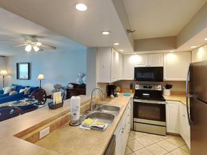 a kitchen with a sink and a refrigerator at Perdido Sun #410 in Perdido Key