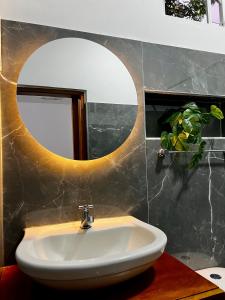 a bathroom with a sink and a mirror at Sol de Coveñas Caracol in Guayabal +25 photos