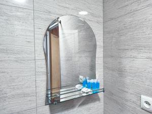 a mirror on a wall in a bathroom at Apartment Panorama in Tbilisi City +87 photos