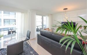 a living room with a couch and a glass table at Awesome Apartment In Oostende With Wifi in Ostend
