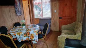 a dining room with a table and chairs and a table and chairsktop at Cabañas Manolo in Osorno