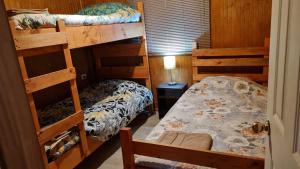 a room with two bunk beds and a bed at Cabañas Manolo in Osorno