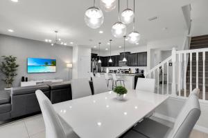 a kitchen and living room with a white table and chairs at Exceptional House 5BD4.5BA Private Pool WW8907 in Kissimmee