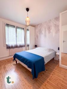 a bedroom with a bed with a blue blanket at Tranquiloue - Maison de Campagne - PuyduFou in Treize-Vents