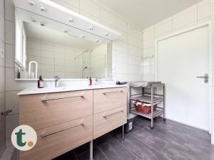 a bathroom with a sink and a large mirror at Tranquiloue - Maison de Campagne - PuyduFou in Treize-Vents +16 photos