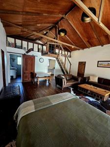a bedroom with a bed and a living room at Barn on the Burnett, Mundubbera in Mundubbera