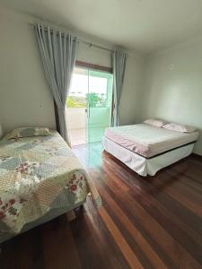 Ένα ή περισσότερα κρεβάτια σε δωμάτιο στο Casa Ampla em Região Metropolitana de Belém