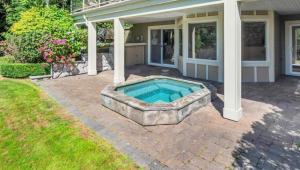 a swimming pool in the backyard of a house at Luxury 5BR Villa, Gym, Theater & Ocean Views in West Vancouver