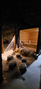 a cave with a fireplace with logs and lights at Domek pod Kozińcem SAUNA JACUZZI Zakopane in Zakopane