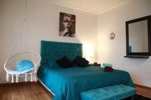 a bedroom with a blue bed and a swing at Hostal Sueños De Lujo in Talca +37 photos