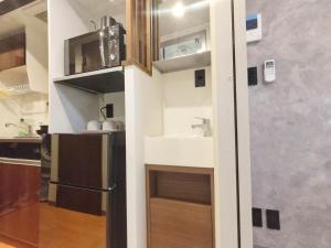 a small kitchen with a sink and a refrigerator at PA Shinjuku St a-9mins -Higashishinjuku subway-5mins-新宿-步行伊势丹8分-MAX4p in Tokyo +20 photos