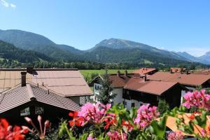 a group of buildings with mountains in the background at Hotel Sonnleiten in Reit im Winkl