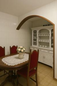 a kitchen with a table with a vase of flowers on it at Private Pool River View Villa in Baião